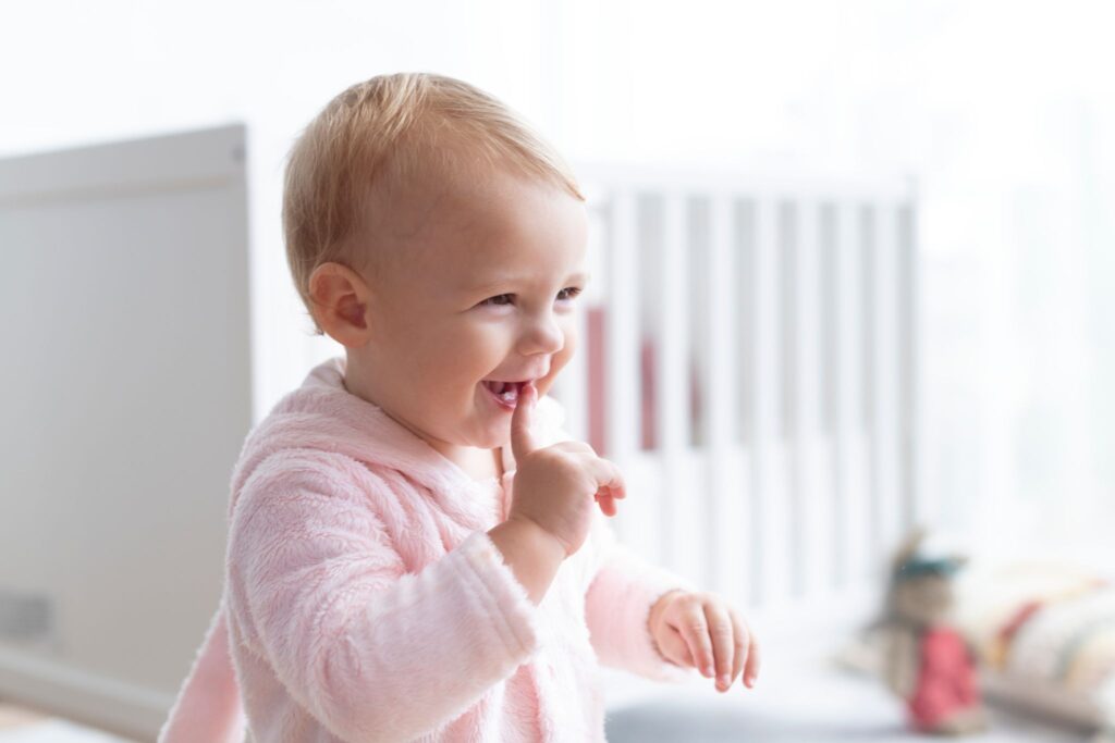 a baby with finger in mouth