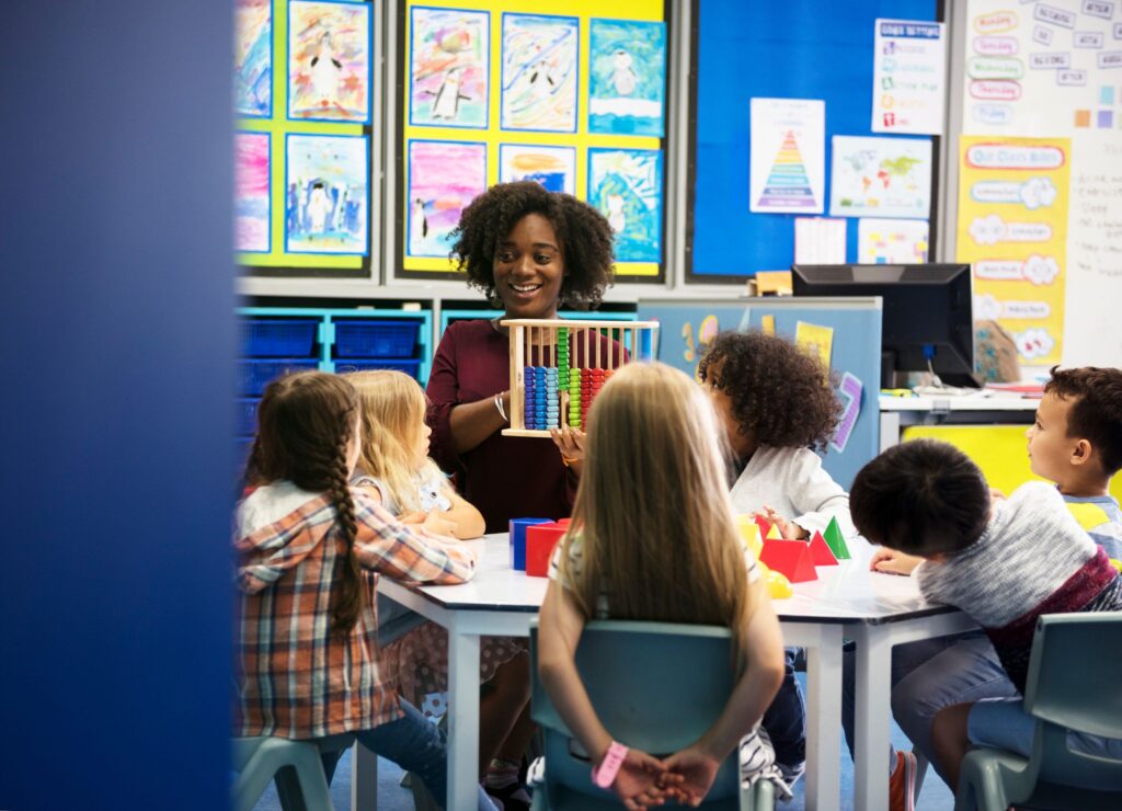 a person holding a toy in front of a group of children