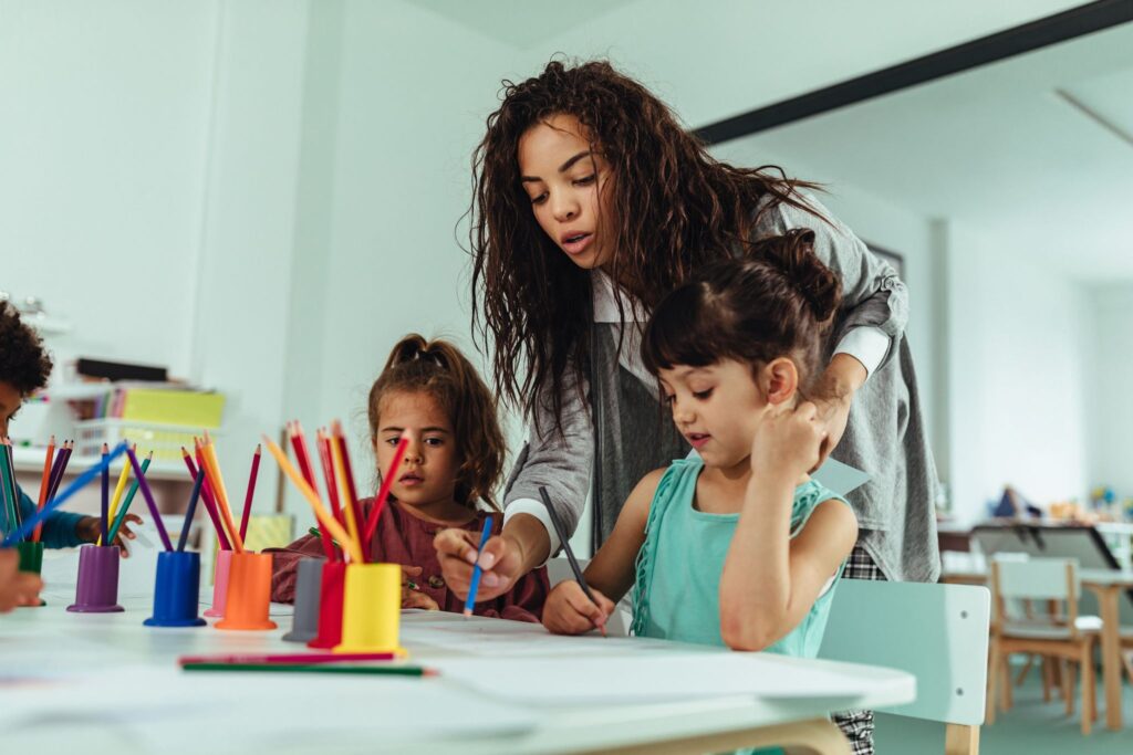 a person and two children painting
