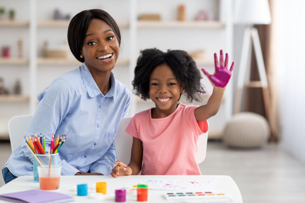 a person and a child painting
