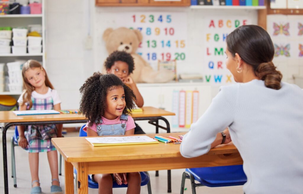 a teacher and children in a classroom