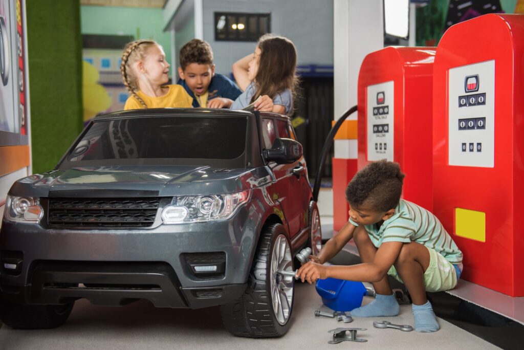 Kids playing in a small motorized toy car